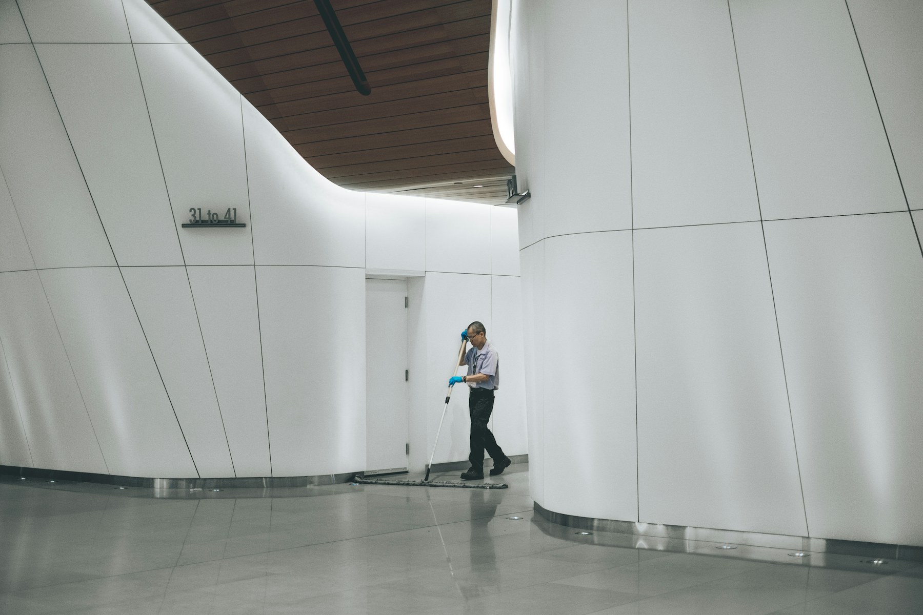 A professional cleaner mopping a polished commercial facility